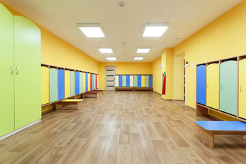 Yellow red and blue colored empty changing room in the kindergarten.
