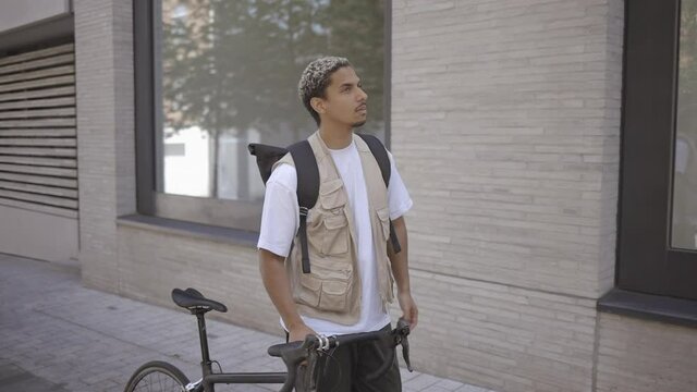 photographer walking through London with his bike. Slow motion 50fps conformed to 25fps