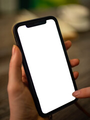 a smartphone in the hands of a girl in a cafe