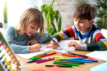 Fototapeta premium Smiling sibling doing homework together
