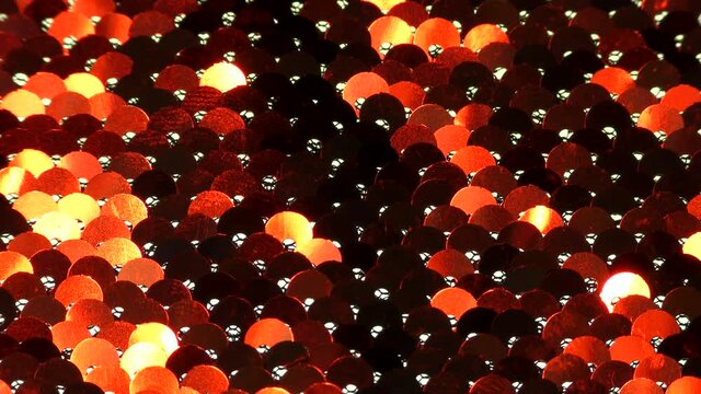 Abstract colorful texture of bright sequins. Glamor background with glittering multi-colored sequins on fabric, macro. Beautiful bright wallpaper with a pattern of round sequins.