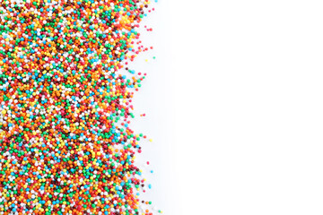 Colorful sprinkles on white background, top view. Confectionery decor