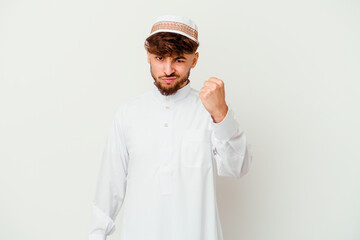 Young Arab man wearing the typical arabic costume isolated on white background showing fist to camera, aggressive facial expression.