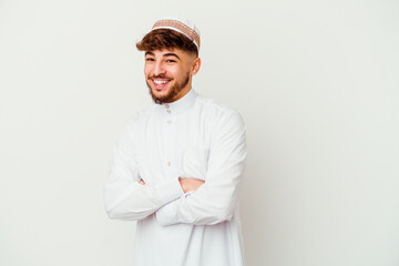 Young Arab man wearing the typical arabic costume isolated on white background laughing and having fun.