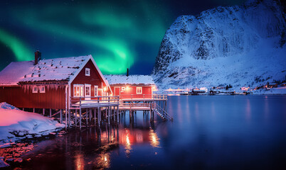 Scenic photo of winter fishing village with northern lights. stunning natural background. Picturesque Scenery of Reinefjord one most popular place of Lofoten islands. Norway. ideal resting place.