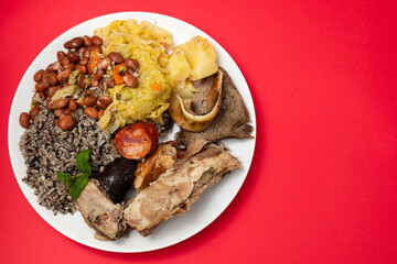 typical portuguese dish boiled meat, smoked sausages and vegetables on white dish
