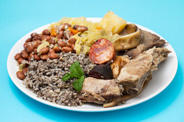 typical portuguese dish boiled meat, smoked sausages and vegetables on white dish