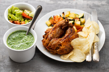 typical portuguese smoked sausage alheira with chips and greens