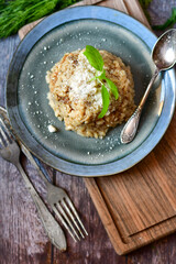 Italian mushroom risotto with parmesan cheese and fresh  parsley on rustic background