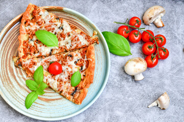  Close up of    hot italian pizza   classic ham. Fresh basil,tomato sauce ,mozzarella cheese , mushrooms and  minced meat .Concept poster for Restaurants or pizzerias. Top view