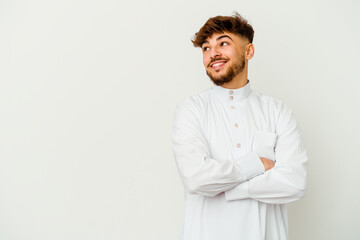 Young Moroccan man wearing a typical arab clothes isolated on white background smiling confident with crossed arms.