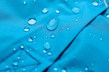 Light blue waterproof fabric with water drops as background, closeup