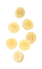 Slices of tasty ripe banana falling on white background