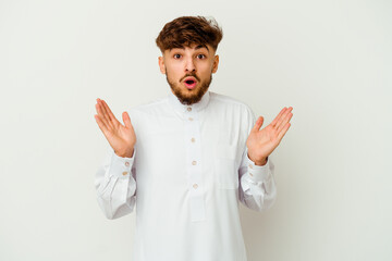 Young Moroccan man wearing a typical arab clothes isolated on white background surprised and shocked.