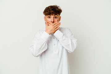 Young Moroccan man wearing a typical arab clothes isolated on white background shocked covering mouth with hands.