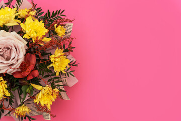 Floral arrangement, yellow chrysanthemum and pink rose in flower bouquet on pink background