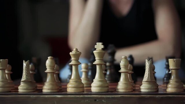 Woman playing Chess at Home during the Coronavirus Lockdown. Close Up. 4K Resolution.