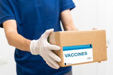 Man holds the vaccine box against white background