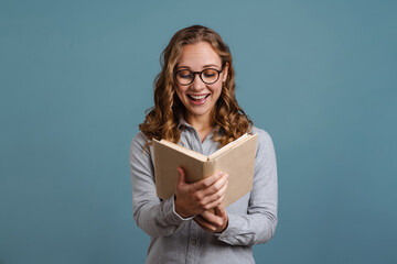 Smiling attractive young woman reading a book