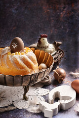 Easter composition with homemade ring cake and decors on grunge background