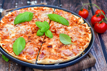  Close up of    hot italian pizza   classic ham. Fresh basil,tomato sauce ,mozzarella cheese , mushrooms and  minced meat .Concept poster for Restaurants or pizzerias. Top view