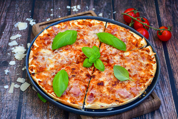 Close up of    hot italian pizza   classic ham. Fresh basil,tomato sauce ,mozzarella cheese , mushrooms and  minced meat .Concept poster for Restaurants or pizzerias. Top view