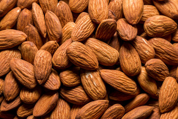 Whole almond nuts background. Vegetarian healthy snack. Organic food. Vegetable diet.