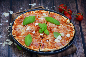  Close up of    hot italian pizza   classic ham. Fresh basil,tomato sauce ,mozzarella cheese , mushrooms and  minced meat .Concept poster for Restaurants or pizzerias. Top view
