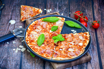  Close up of    hot italian pizza   classic ham. Fresh basil,tomato sauce ,mozzarella cheese , mushrooms and  minced meat .Concept poster for Restaurants or pizzerias. Top view