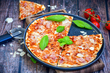  Close up of    hot italian pizza   classic ham. Fresh basil,tomato sauce ,mozzarella cheese , mushrooms and  minced meat .Concept poster for Restaurants or pizzerias. Top view
