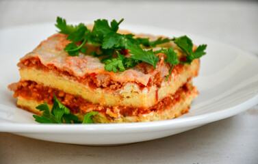   Delicious Home made keto diet  Lasagna bolognese  with  Lupin Flour, minced meat,tomato sauce and spinach  on a wooden rustic  background.Home made low carb italian meal
