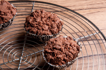 Freshly baked chocolate muffins on steel tray