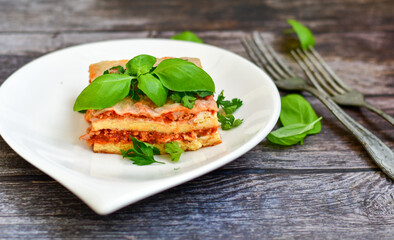   Delicious Home made keto diet  Lasagna bolognese  with  Lupin Flour, minced meat,tomato sauce and spinach  on a wooden rustic  background.Home made low carb italian meal