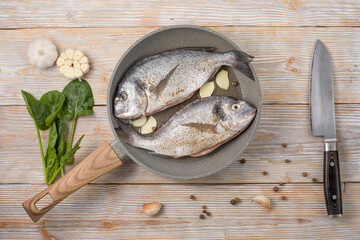 Freshly caught uncooked dorado and ingredients flat lay