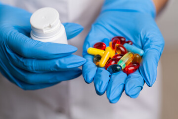 Doctor close up holding white pills for weight loss
