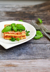   Delicious Home made keto diet  Lasagna bolognese  with  Lupin Flour, minced meat,tomato sauce and spinach  on a wooden rustic  background.Home made low carb italian meal