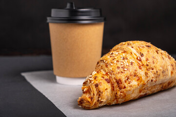 Croissant and coffee. Takeaway breakfast