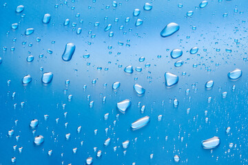 Moisturizing liquid blue drops on pastel background. Cosmetic toner or Water Drops. Hyaluronic serum Bubbles close-up.