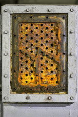 Tube sheet plate of pump three-way heat exchanger or boiler closeup texture macro background full of cracks insoluble hard mineral deposits salts scale and corrosion. Trypophobia concept background