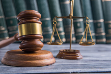 Law and Justice Symbols with law books on background.