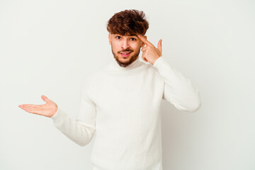 Young Moroccan man isolated on white background showing a disappointment gesture with forefinger.