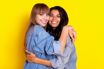 Profile photo of pretty cheerful ladies diversity hugging have good mood isolated on yellow color background