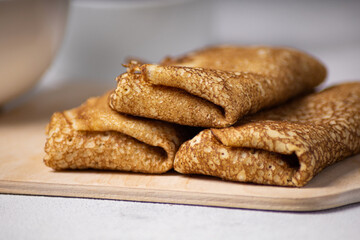 Pancakes roll on a light background close-up