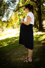 A pregnant woman in a park