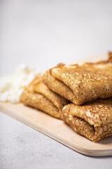 Pancakes roll on a light background close-up