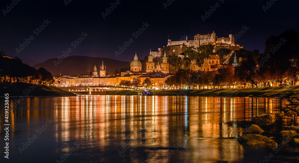 Wall mural fantastic colorful evening view on salzburg historical city. castle hohensalzburg with night street 