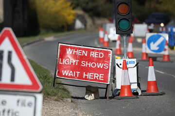 Country lane road work temporary traffic lights and signs