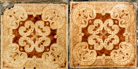Dilapidated Portuguese traditional tiles Azulejos with ornage floral and geometric pattern.