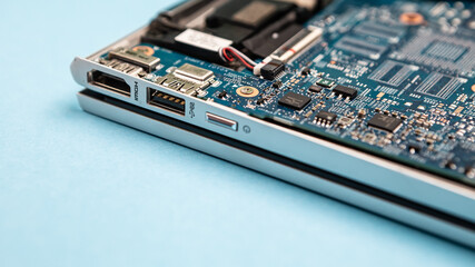 Obraz premium Close up laptop without cover inside disassembling in repair shop. Computer service engineer technician workplace repairing fixing broken components upgrade system, microelectronics copy space