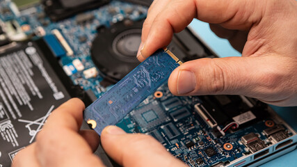 Close up laptop without cover inside disassembling in repair shop. Computer service engineer...